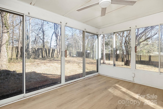 unfurnished sunroom featuring ceiling fan