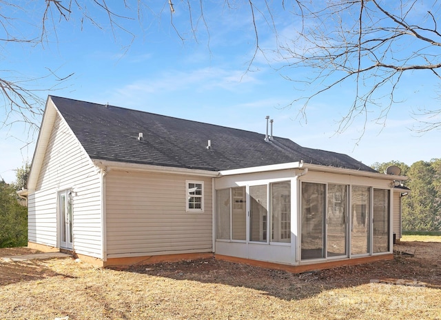 rear view of house featuring a sunroom