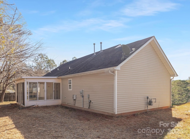 view of side of property featuring a sunroom