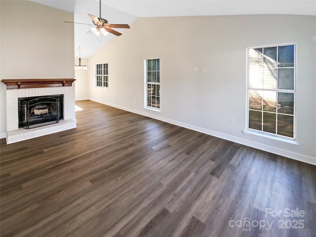 unfurnished living room with dark hardwood / wood-style flooring, lofted ceiling, ceiling fan, and a fireplace