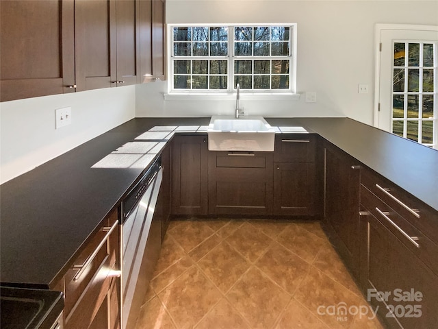 kitchen featuring sink, light tile patterned floors, dark brown cabinets, and stainless steel dishwasher