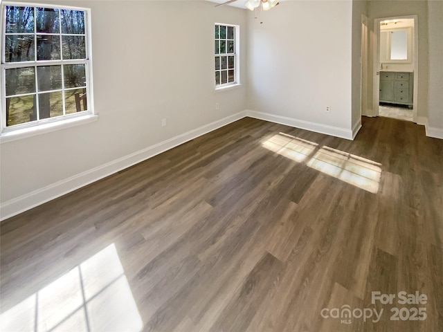 spare room featuring ceiling fan and dark hardwood / wood-style flooring