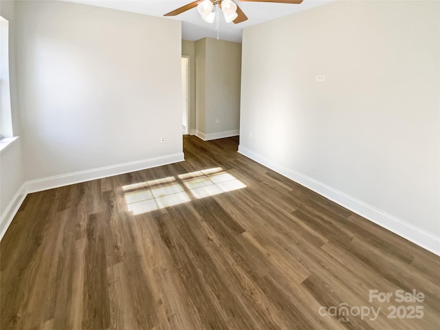 empty room featuring ceiling fan and dark hardwood / wood-style flooring