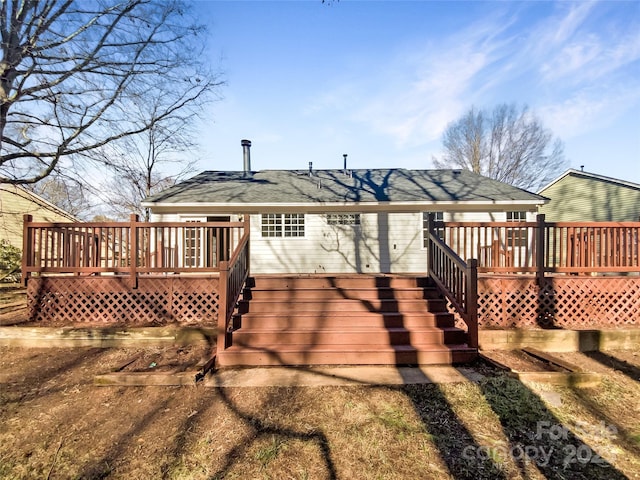 rear view of house featuring a wooden deck