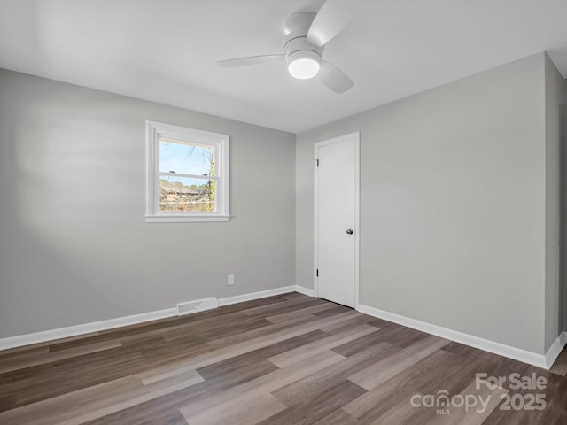 spare room featuring ceiling fan and wood-type flooring