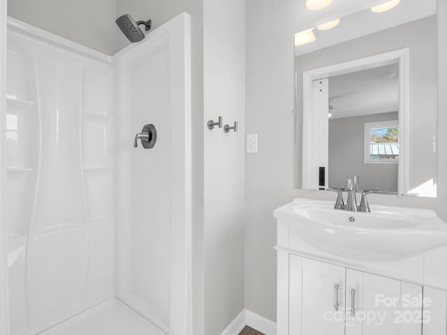 bathroom with vanity and a shower