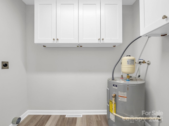 utility room featuring water heater