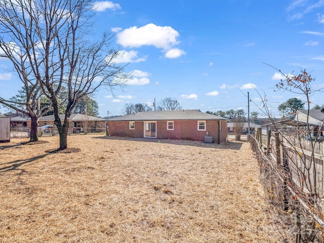 back of property featuring a yard and central air condition unit