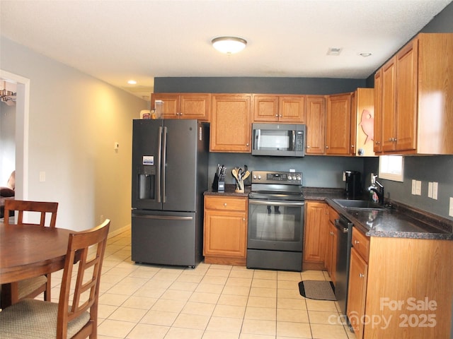 kitchen featuring light tile patterned floors, sink, and black appliances