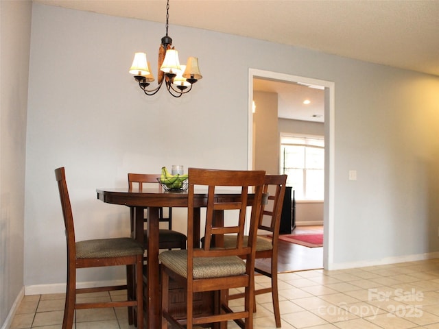 dining space with an inviting chandelier and light tile patterned floors