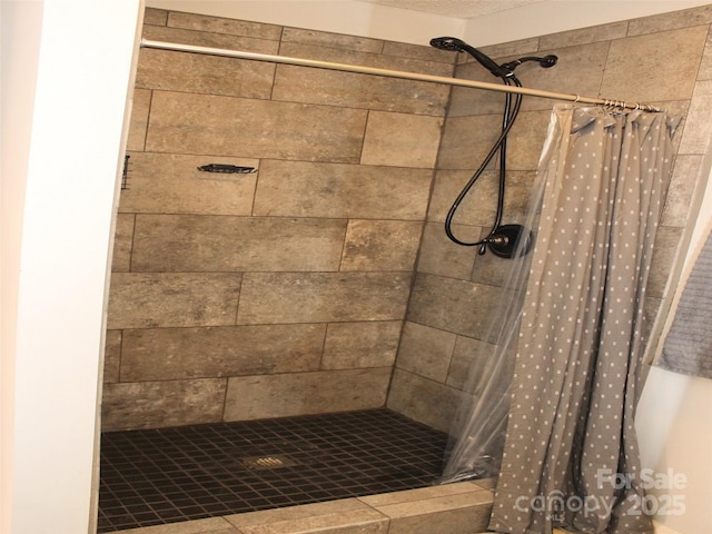 bathroom with a textured ceiling and walk in shower