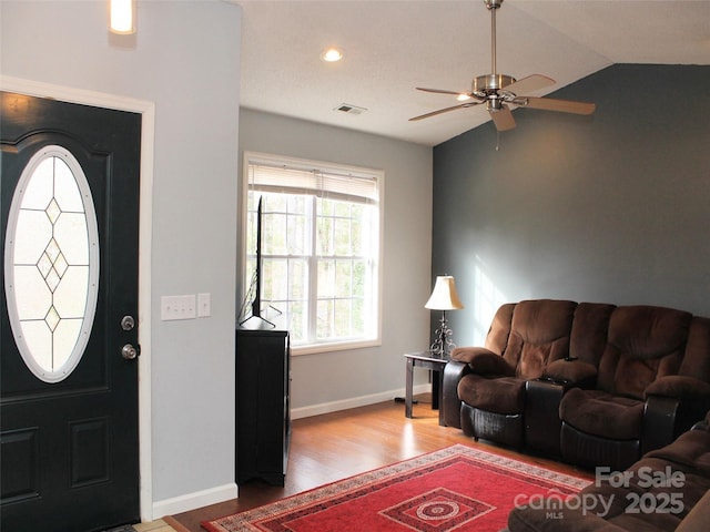 entrance foyer featuring ceiling fan, lofted ceiling, and hardwood / wood-style floors