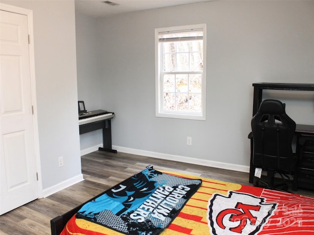 bedroom with dark hardwood / wood-style floors