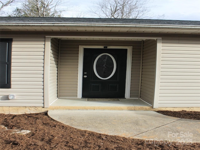 view of exterior entry featuring covered porch