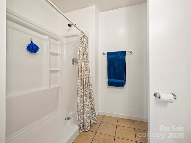 bathroom with curtained shower and tile patterned floors