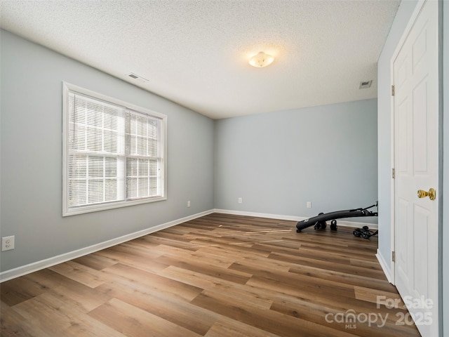 interior space with hardwood / wood-style floors and a textured ceiling