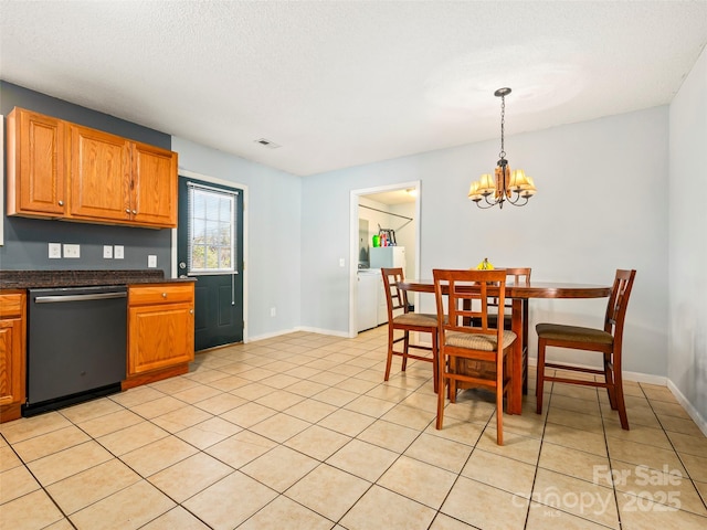 kitchen with pendant lighting, dishwasher, light tile patterned floors, a notable chandelier, and a textured ceiling