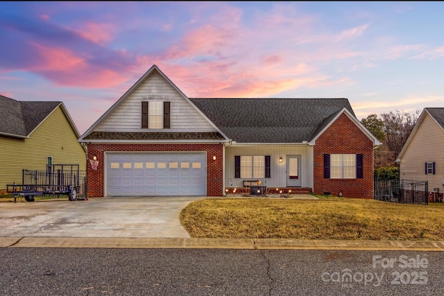 front of property with a garage and a yard