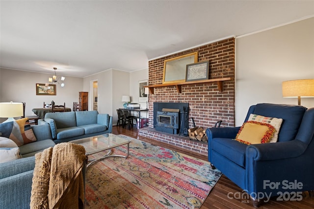 living room with an inviting chandelier, ornamental molding, and dark hardwood / wood-style floors