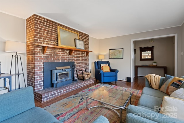 living room with ornamental molding, dark hardwood / wood-style floors, and a wood stove