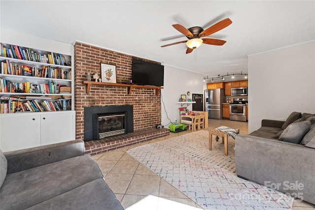 tiled living room featuring ceiling fan and a fireplace