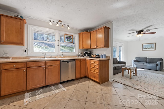 kitchen with sink, a textured ceiling, light tile patterned floors, dishwasher, and ceiling fan