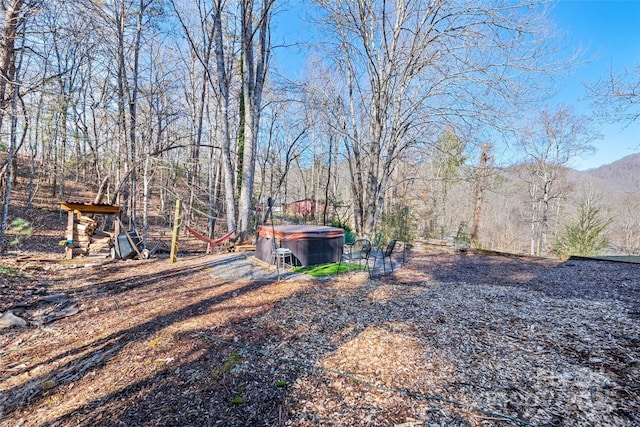 view of yard featuring a hot tub and a mountain view