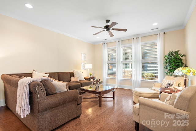 living room with hardwood / wood-style flooring, crown molding, and ceiling fan