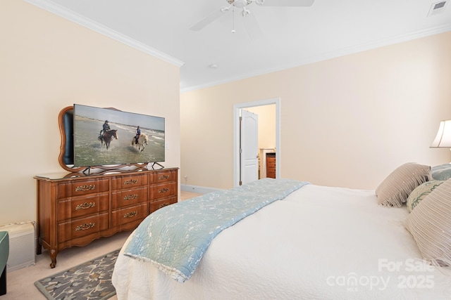 carpeted bedroom with ornamental molding and ceiling fan