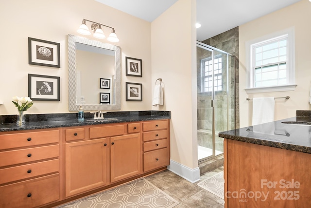 bathroom with vanity, tile patterned floors, and walk in shower