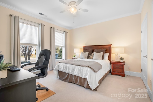 bedroom with ornamental molding, light colored carpet, and ceiling fan