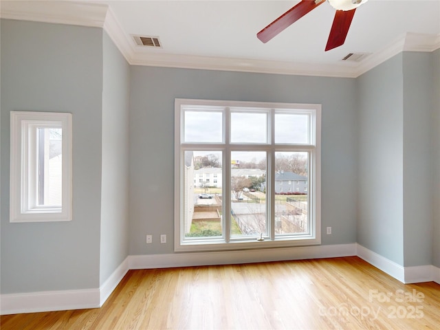 unfurnished room featuring light hardwood / wood-style flooring, ornamental molding, and ceiling fan