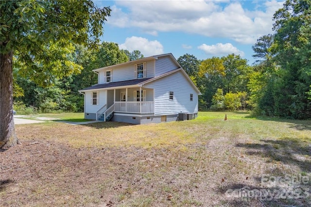 back of property featuring central AC, covered porch, and a lawn