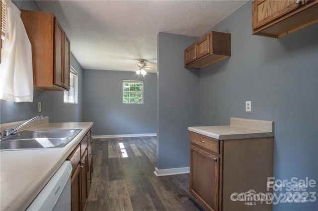 kitchen with sink, dishwasher, ceiling fan, a textured ceiling, and dark hardwood / wood-style flooring