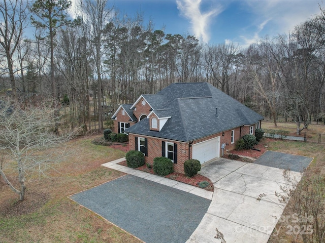 view of front of home with a garage and a front lawn