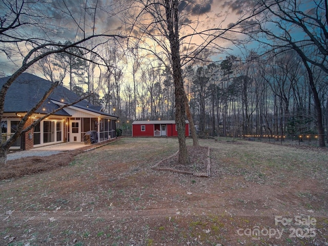 yard at dusk with an outbuilding