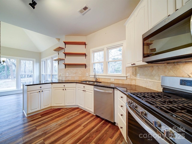 kitchen featuring dark wood-type flooring, stainless steel appliances, sink, and white cabinets