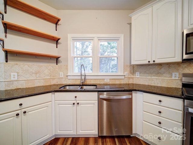 kitchen featuring white cabinetry, stainless steel appliances, sink, and tasteful backsplash