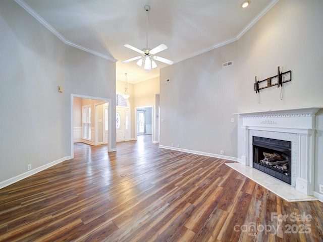 unfurnished living room with ornamental molding, high vaulted ceiling, dark wood-type flooring, and ceiling fan