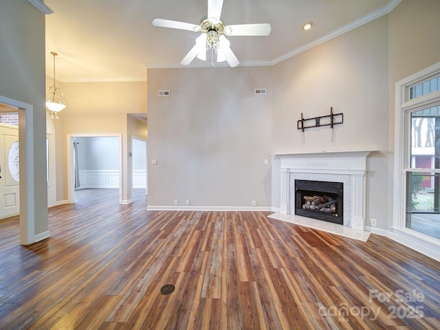 unfurnished living room featuring ornamental molding, dark hardwood / wood-style floors, ceiling fan, and a high end fireplace