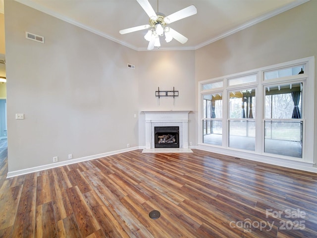 unfurnished living room featuring ornamental molding, dark hardwood / wood-style floors, and ceiling fan