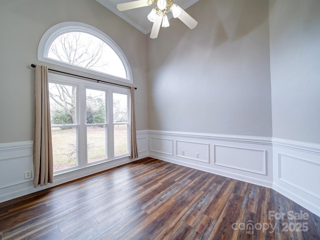 spare room with ceiling fan and dark hardwood / wood-style flooring