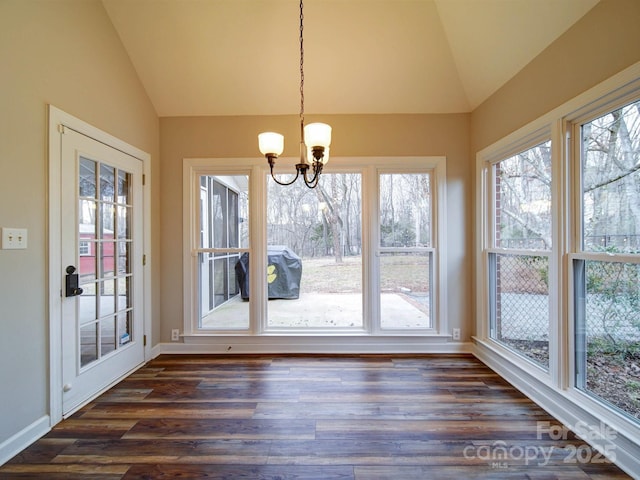 unfurnished sunroom featuring lofted ceiling, a notable chandelier, and a healthy amount of sunlight