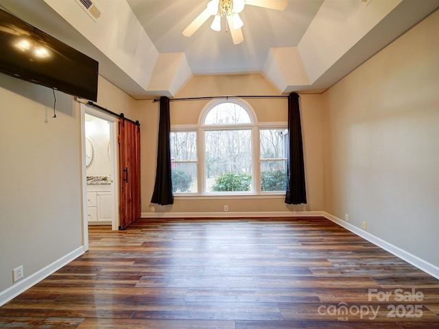 empty room with vaulted ceiling, dark wood-type flooring, and ceiling fan