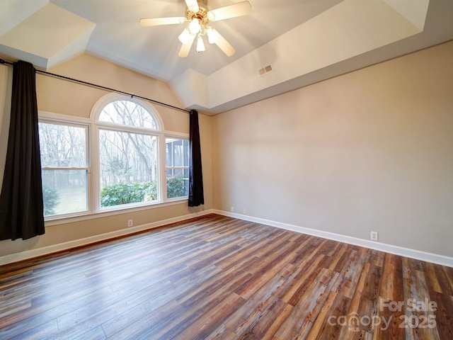 spare room with hardwood / wood-style flooring, lofted ceiling, and ceiling fan