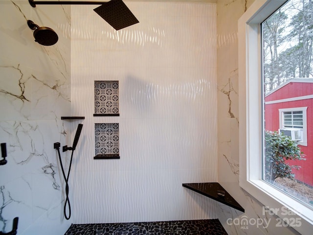 bathroom with a tile shower, cooling unit, and plenty of natural light