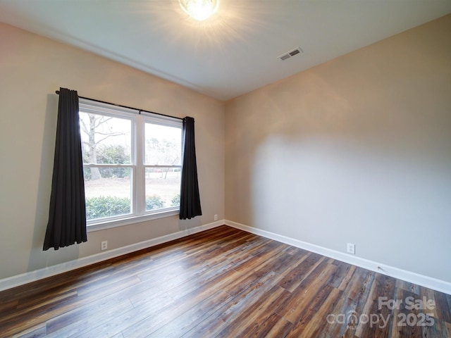 unfurnished room featuring dark hardwood / wood-style flooring