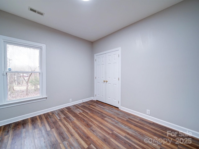 unfurnished room featuring dark hardwood / wood-style flooring