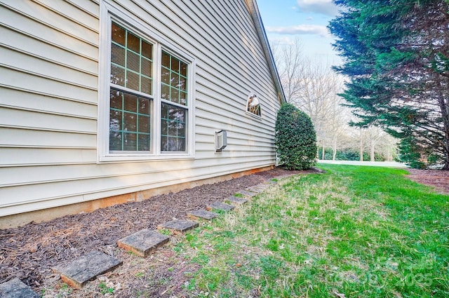 view of side of property with a lawn