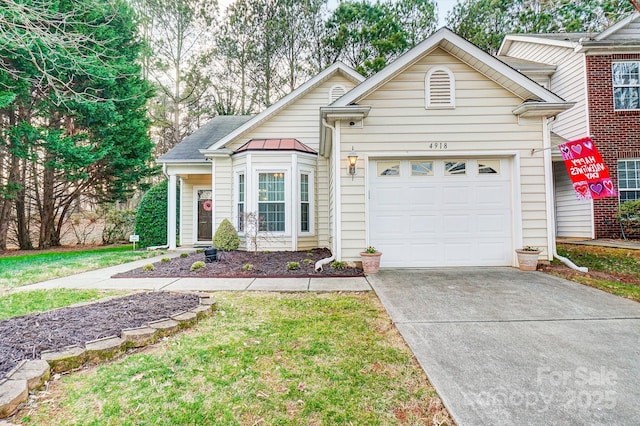 view of front of house with a garage and a front yard